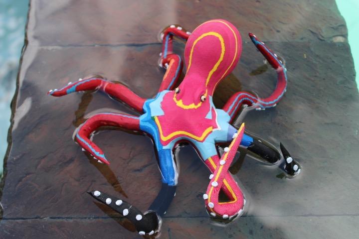 Hand-carved multicolored octopus sculpture made of upcycled flip flops by Ocean Sole.