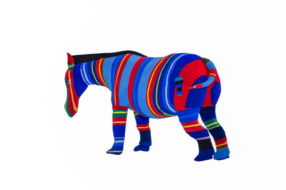 Hand-carved multicolored zebra sculpture made of upcycled flip flops by Ocean Sole.