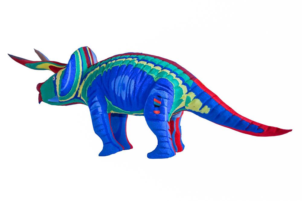 Hand-carved multicolored triceratops sculpture made of upcycled flip flops by Ocean Sole.