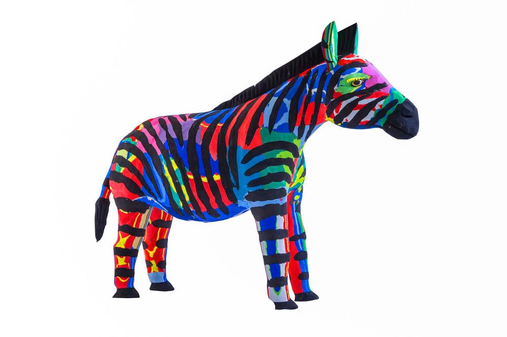 Hand-carved multicolored zebra sculpture made of upcycled flip flops by Ocean Sole.