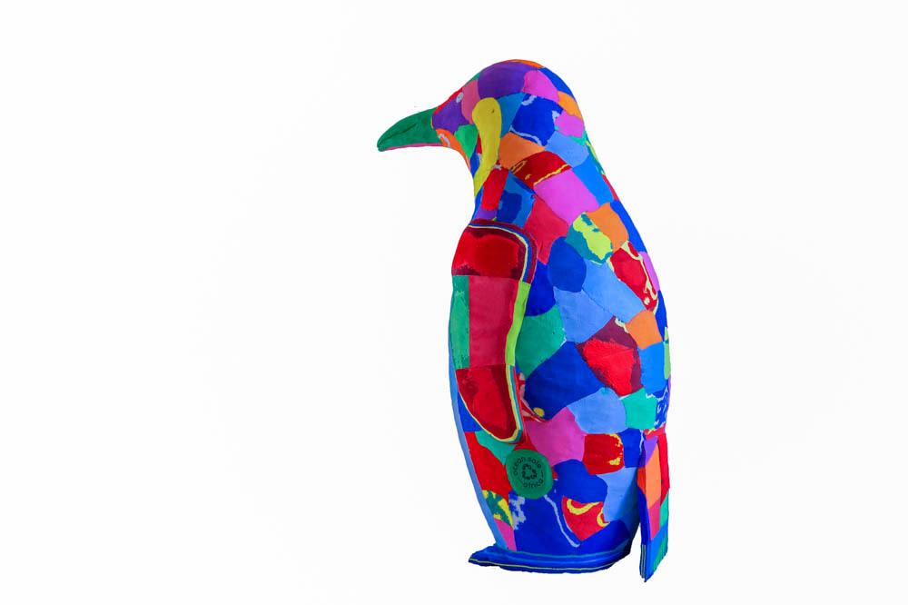 Hand-carved multicolored penguin sculpture made of upcycled flip flops by Ocean Sole.