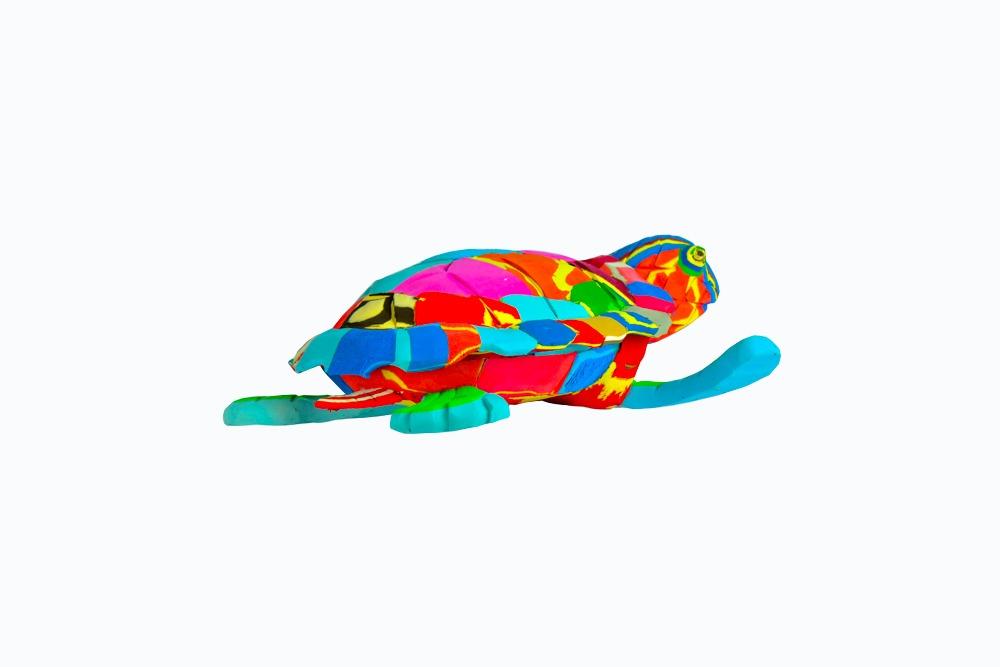 Hand-carved multicolored turtle sculpture made of upcycled flip flops by Ocean Sole.